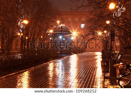 Scenic view of empty night alley in the city park in rain