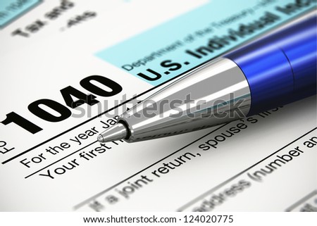 Tax form business financial concept: macro view of individual return tax form and blue metal ballpoint pen