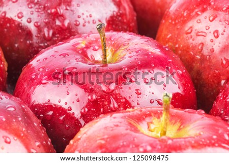 Macro of fresh red wet apples with water drops