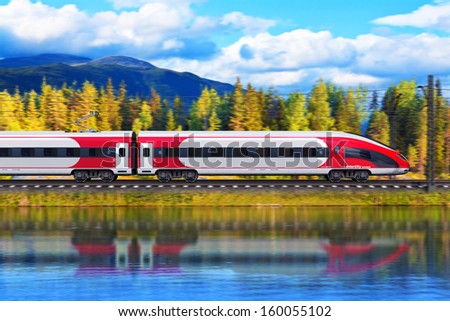 Railroad travel and railway tourism transportation industrial concept: scenic summer view of modern high speed passenger train on tracks with lake or sea and mountains in background with motion blur