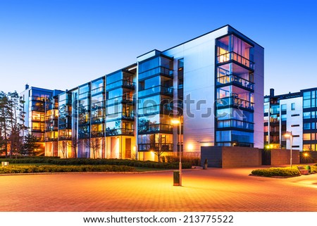 House building and city construction concept: evening outdoor urban view of modern real estate homes
