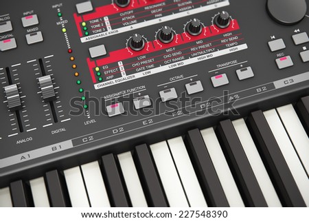 Creative abstract electronic music instrument and art creation concept: macro view of black professional digital musical piano synthesizer with sliders, buttons, tuning knobs and other controls