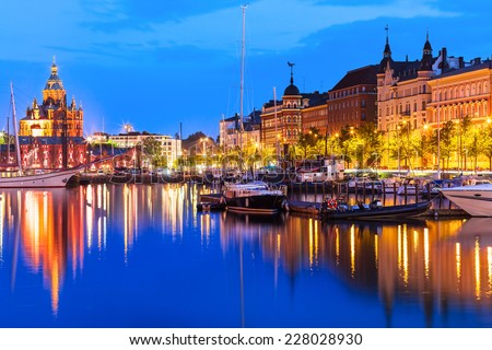 Scenic summer evening panorama of the Old Port pier architecture with tall historical sailing ships, yachts and boats and Uspenski Orthodox Cathedral in the Old Town in Helsinki, Finland