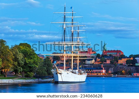 Scenic summer evening view of the Old Town (Gamla Stan) with historical tall sailing ship AF Chapman at Skeppsholmen Island in Stockholm, Sweden
