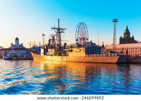 Scenic sunset evening view of the Old Town harbor port with docked military ship in Helsinki, Finland