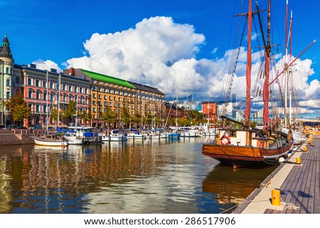 Scenic summer view of the Old Port pier architecture with ships, yachts and other boats in the Old Town of Helsinki, Finland