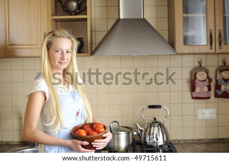 Young housewife posing in kitchen
