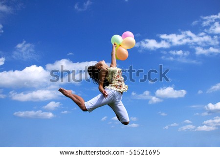 young woman flying with colorful balloons