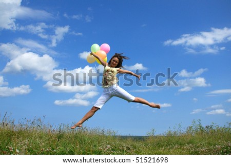 Happy young woman flying with colorful balloons