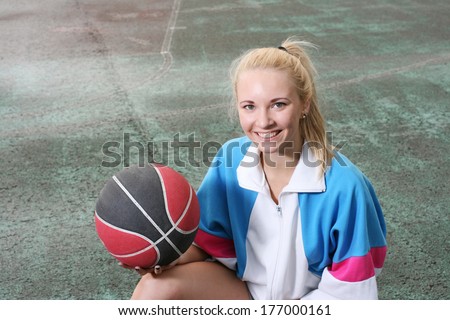 Amiling girl with basketball ball