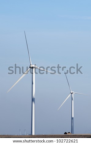 view of two  windmills for renewable electric  energy production