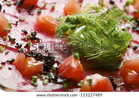 forefront of carpaccio of tuna  with diced tomatoes