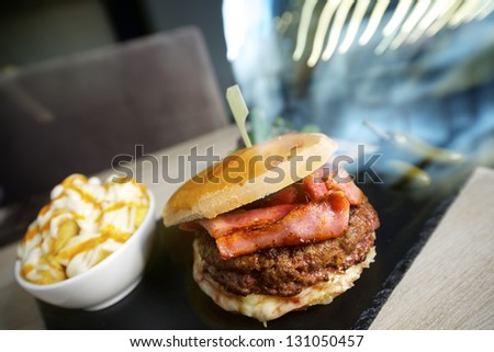 close-up of a burger with bacon in a restaurant