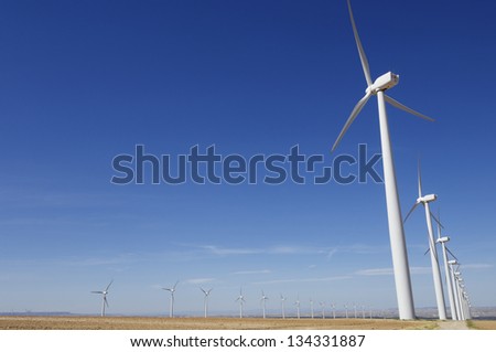 aligned group of windmills for renewable electric energy production