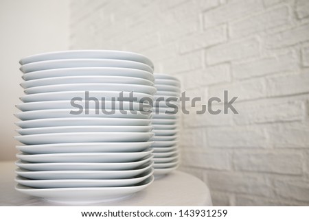 group of white porcelain plates stacked