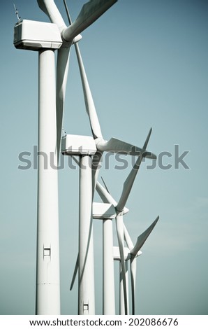 aligned group of windmills for renewable electric energy production, Cintruenigo, Navarre, Spain