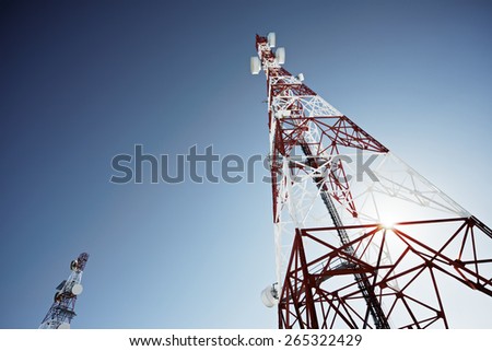 Telecommunications tower with clear blue sky.