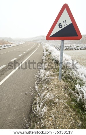 descent traffic sign in a snowy landscape