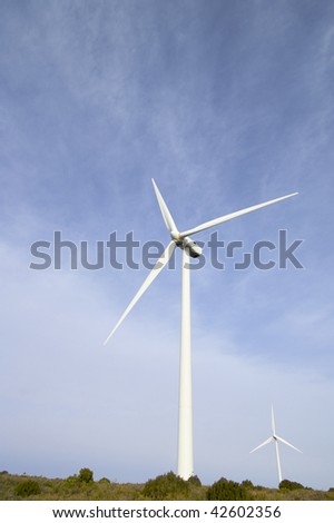 two windmills with cloudy sky
