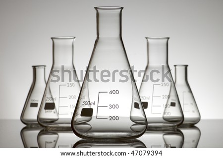 five empty flasks on a white backlight