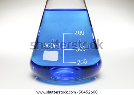 foreground of a five hundred ml Erlenmeyer flask with bright blue liquid