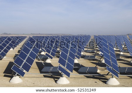 solar field with blue and cloudy sky