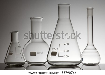 group of four empty laboratory flasks on a white background