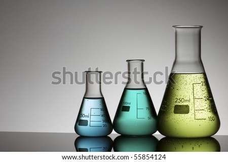group of three conical flasks containing liquid