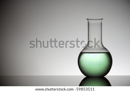 flask with green liquid and white background