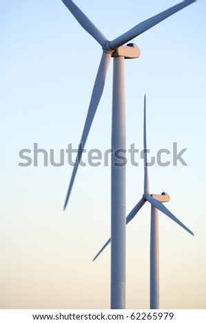 foreground at sunset two windmills with clear sky
