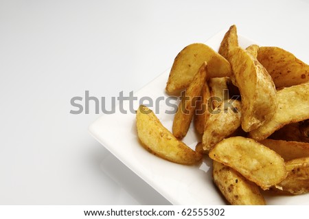 forefront of a fried potato slices on a white plate
