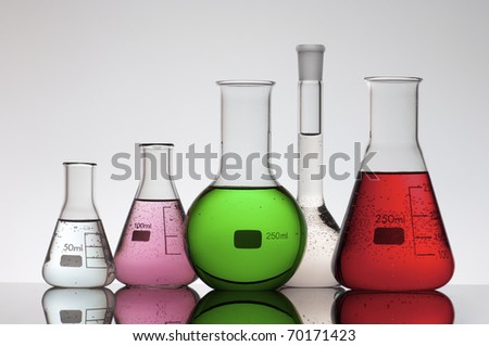 group of laboratory flasks brightly colored liquid