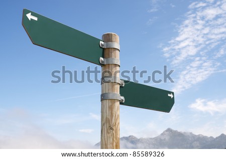 view of two wooden directional signs on a pole