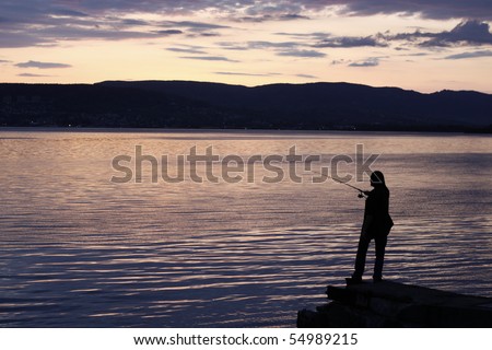 Person fishing just after sunset