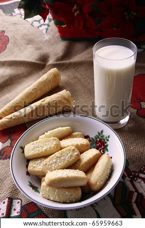 Christmas biscuits. Finnish cookie sticks, scandinavian cones  and a glass of milk on a beige table cloth