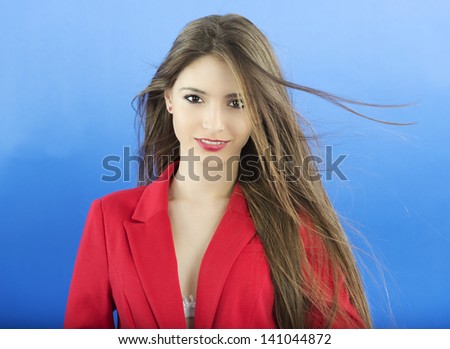 Portrait of urban business woman wearing tie, isolated on blue