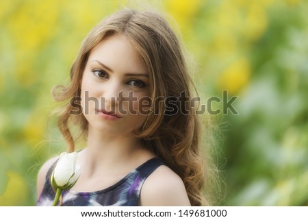 Romantic woman with rose lying on sunflowers field