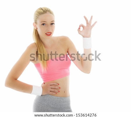 Young attractive, beautiful fitness woman smile holding thump up sign, isolated over white background.