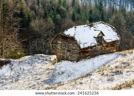Old wooden barn in the countryside, in the winter