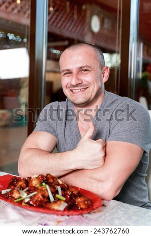 Handsome man eating at the restaurant