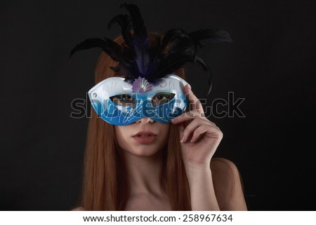 Close up portrait of woman in blue mask