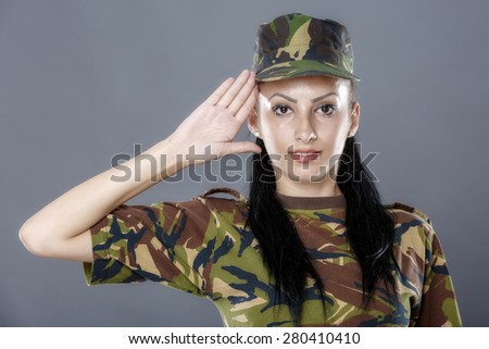 Woman army soldier saluting isolated on gray background