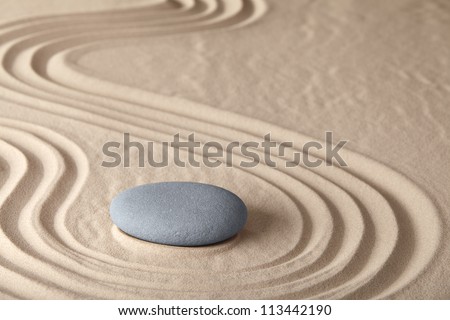Zen meditation stone traditional Japanese garden with sand and rock pattern concept for simplicity harmony and serenity helps in concentration and relaxation