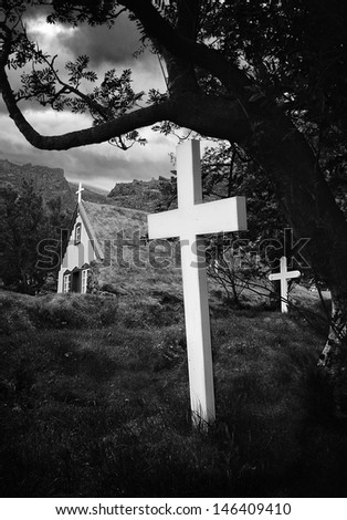 old Iceland church and cemetery grass roof building and white crosses in graveyard beautiful traditional architecture BW Small village Hof