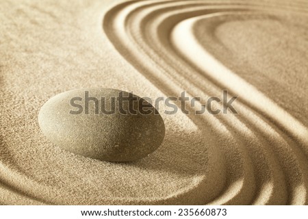 zen stone in japanese meditation garden. Rock and sand stands for balance harmony and spirituality. Spa wellness background