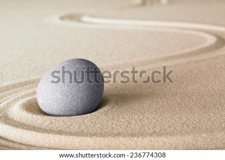 Japanese zen garden stone with lines in sand. Balance and harmony for relaxation and meditation.
