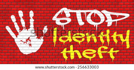 identity theft stop warning sign stealing ID online is an internet or cyber crime graffiti on red brick wall, text and hand