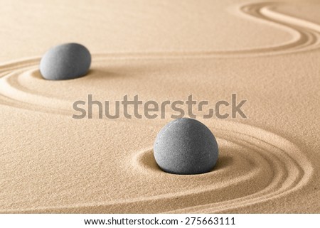 zen stones and lines in sand of Japanese garden. Spa wellnes therapy background. Purity harmony and balance.