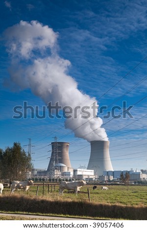 cooling towers of a nuclear power plant atomic energy cooling towers white smoke and blue sky
