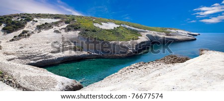 white chalk cliffs eroded coastline blue sky and sea at Caterina di Pittinuri Sardinia Italy panorama landscape beautiful travel holiday vacation natural tourism attraction impressive rock formation